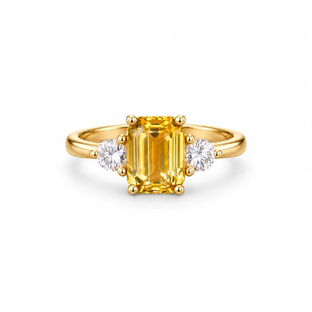 A rectangular yellow sapphire with a round diamond on each side.