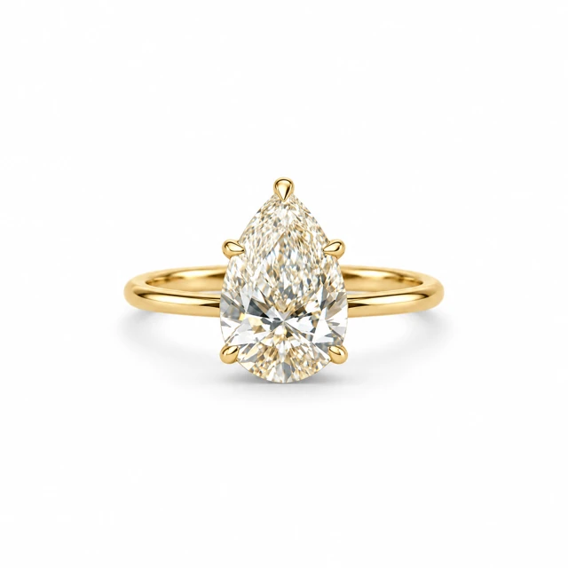 A pear-shaped diamond on a simple, slim band.