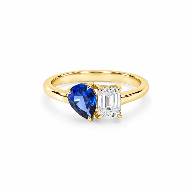 A pear-shaped blue sapphire and a rectangular diamond sitting side by side.