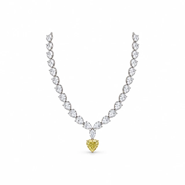 A necklace of pear-shaped diamonds with a yellow sapphire heart hanging at the centre.