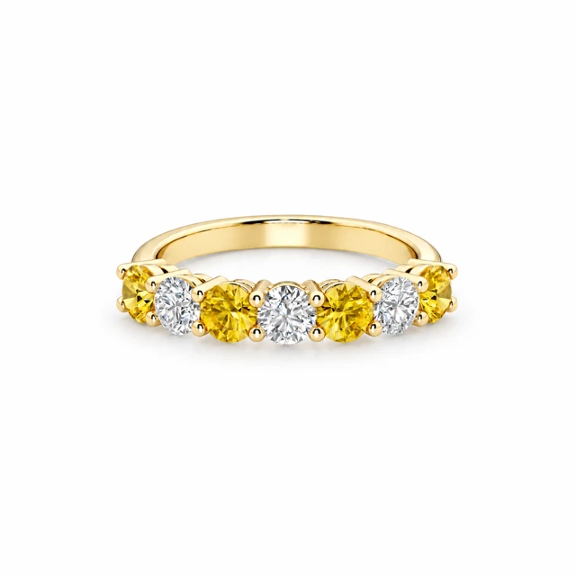 A row of seven round gemstones, alternating between yellow sapphires and diamonds.
