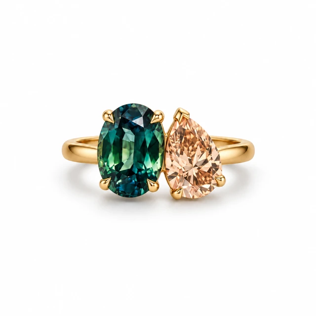 An oval teal sapphire and a pear-shaped champagne diamond sitting side by side.