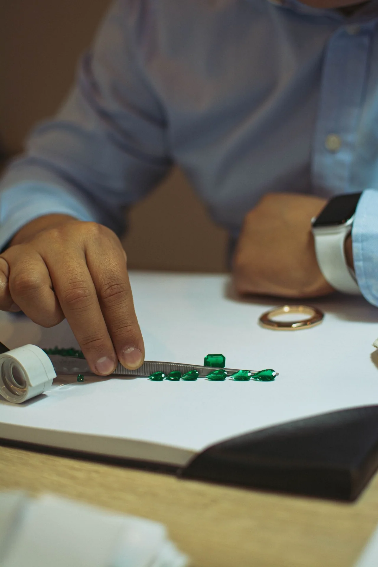 Emerald gemstones being selected by hand